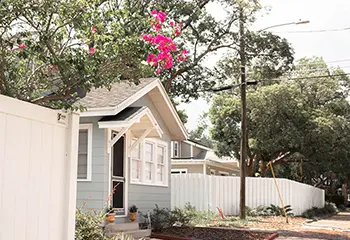 A house with pink flowers in the yard.